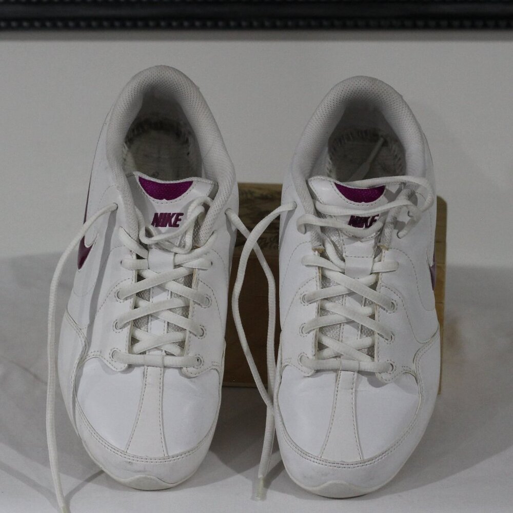 Nike running shoes Leather white in color with purple Nike mark on side